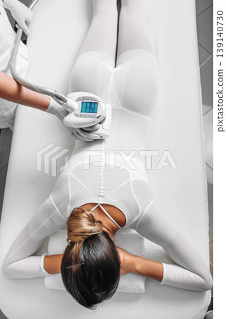 Beautiful woman receiving lpg massage against cellulite Beautiful woman receiving lpg massage against cellulite 139140730