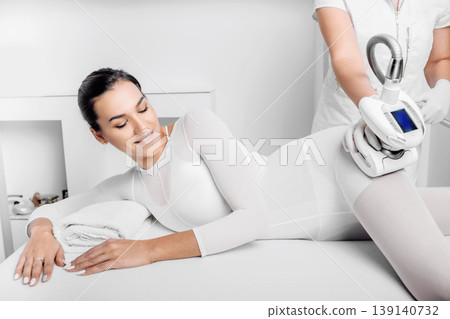 Beautiful woman receiving lpg massage against cellulite Beautiful woman receiving lpg massage against cellulite 139140732