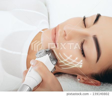 face lifting lpg massage , the woman's face shines with youth and freshness. Anti-aging face contour correction, lifting arrows 139140802