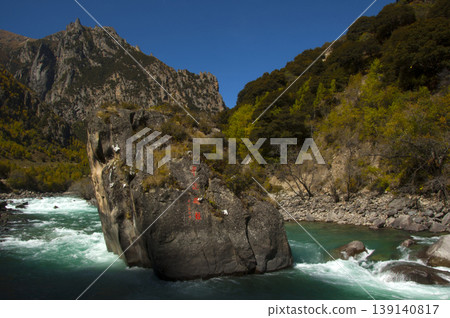 A landscape of rapids and giant rocks flowing through the valleys of Tibetan forest. A landscape of rapids and giant rocks flowing through the valleys of Tibetan forest. 139140817