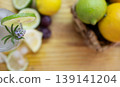 Zenithal photo of iced lemonade drink decorated with fresh lavender.and fruit on wooden table. 139141204