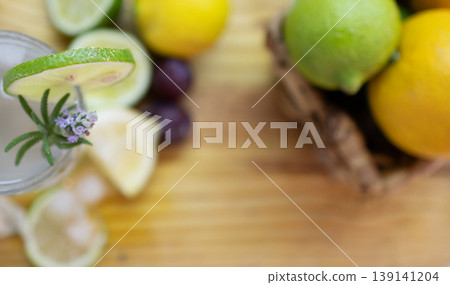 Zenithal photo of iced lemonade drink decorated with fresh lavender.and fruit on wooden table. Zenithal photo of iced lemonade drink decorated with fresh lavender.and fruit on wooden table. 139141204