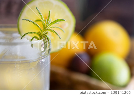 Close up picture of refreshing lemonade drink for a hot summer day. Out of focus background of fresh fruit. Close up picture of refreshing lemonade drink for a hot summer day. Out of focus background of fresh fruit. 139141205