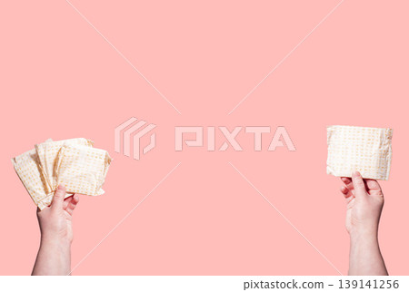 White sanitary pads in hand. Concept of menstruation, ovulation, reproduction, pain and personal feminine hygiene White sanitary pads in hand. Concept of menstruation, ovulation, reproduction, pain and personal feminine hygiene 139141256