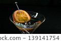 Martini glass with orange slice garnish for celebration 139141754