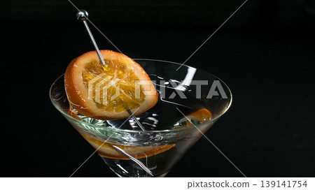Martini glass with orange slice garnish for celebration Martini glass with orange slice garnish for celebration 139141754