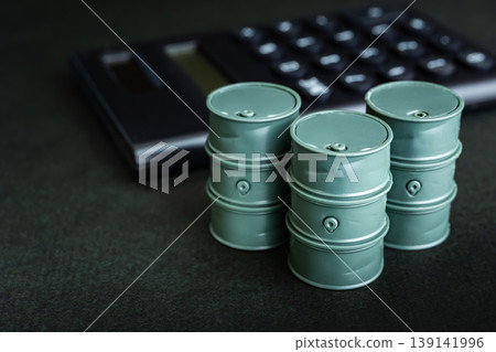 Image of an oil can and a calculator, representing the price of crude oil. Image of an oil can and a calculator, representing the price of crude oil. 139141996