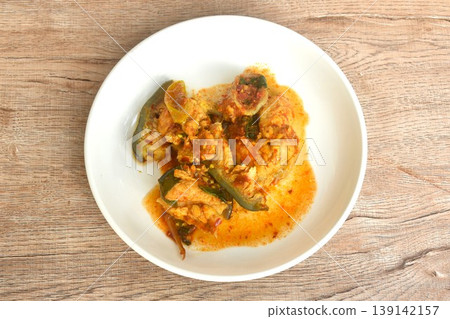 spicy fried Maekong giant catfish with herb and chili curry on plate spicy fried Maekong giant catfish with herb and chili curry on plate 139142157