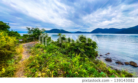 A walking path along the shore of Lake Biwa and the beautiful lake scenery. A walking path along the shore of Lake Biwa and the beautiful lake scenery. 139143082