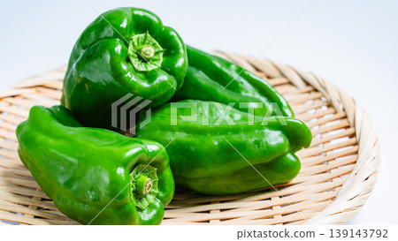 Fresh bell peppers placed on a colander against a white background. Fresh bell peppers placed on a colander against a white background. 139143792