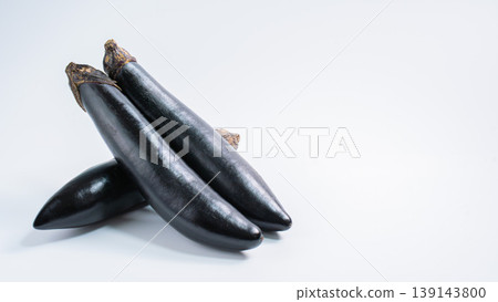 A cutout image of fresh vegetables, featuring long eggplants arranged against a white background. A cutout image of fresh vegetables, featuring long eggplants arranged against a white background. 139143800