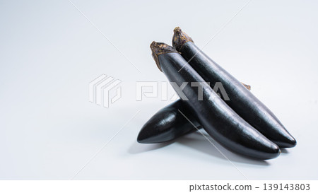 A cutout image of fresh vegetables, featuring long eggplants arranged against a white background. A cutout image of fresh vegetables, featuring long eggplants arranged against a white background. 139143803