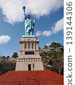 A Statue of Liberty with cherry blossoms in the background, in a park in Oirase Town. 139144306
