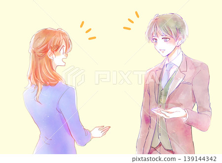 A man and a woman having a conversation; they are office workers. A man and a woman having a conversation; they are office workers. 139144342
