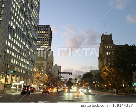 Japanese cityscape at dusk and an Art Deco clock tower Japanese cityscape at dusk and an Art Deco clock tower 139144357