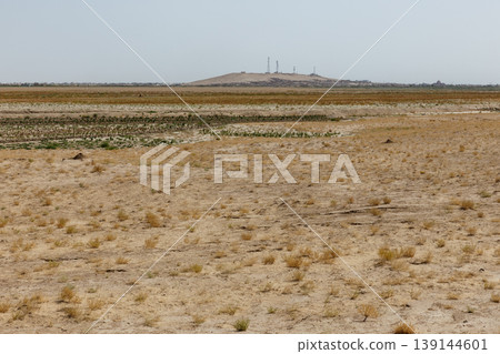 Arid desert landscape with communication towers on hill in Jowzjan Province Afghanistan area Arid desert landscape with communication towers on hill in Jowzjan Province Afghanistan area 139144601