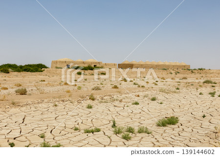 Traditional mud brick domed houses on cracked dry earth in Faryab Province Afghanistan Traditional mud brick domed houses on cracked dry earth in Faryab Province Afghanistan 139144602