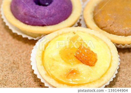 variety of bake Hokkaido cheese tart on the wooden background. variety of bake Hokkaido cheese tart on the wooden background. 139144904