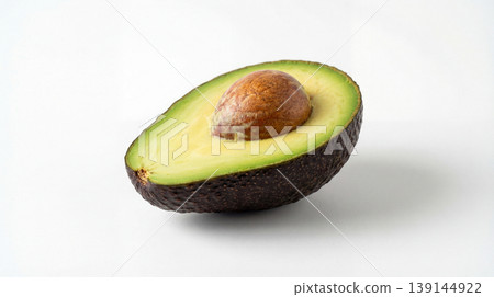 Half avocado with pit and green flesh studio shot on white background still life food photography food item isolated object avocado seed isolated minimalist nutrition copy space background 139144922