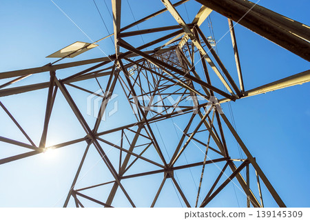 High Voltage Power Transmission Tower Against Blue Sky Low Angle View High Voltage Power Transmission Tower Against Blue Sky Low Angle View 139145309