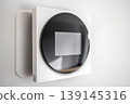 Modern Smart Thermostat on Wall for Home Climate Control 139145316