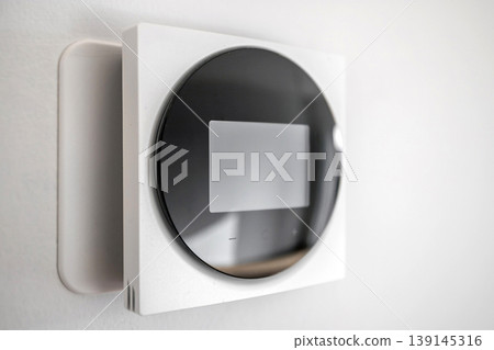 Modern Smart Thermostat on Wall for Home Climate Control 139145316