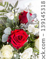Red and White Rose Bouquet with Eucalyptus Leaves in Soft Natural Light 139145318