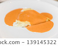 Gourmet Stuffed Pasta with Creamy Sauce on White Plate Close-Up 139145322