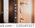 Open Wooden Door with Security Lock and Handle Close-Up 139145327