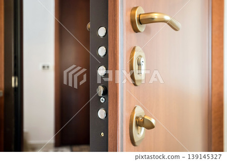 Open Wooden Door with Security Lock and Handle Close-Up Open Wooden Door with Security Lock and Handle Close-Up 139145327