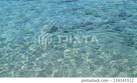 Blue sea water background with small waves and ripples on the surface 139145512