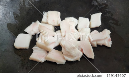 Sliced Raw Pork Fat Cubes in a Pan Preparing for Cooking or Rendering 139145607