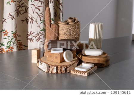 Natural Soap Bars Collection on Wooden Podiums with Rustic Bath Accessories. Assortment of Soaps and Loofah Natural Soap Bars Collection on Wooden Podiums with Rustic Bath Accessories. Assortment of Soaps and Loofah 139145611