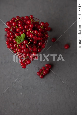 Currants in a bowl on a black background. Red berry. Vitamin berries. Copy space 139145617