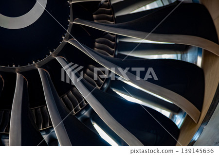 Turbine blades of an aircraft jet engine. Close up Turbines Engine. Aviation Technologies. Aircraft jet black detail during maintenance. Background. Macro. Turbine blades of an aircraft jet engine. Close up Turbines Engine. Aviation Technologies. Aircraft jet black detail during maintenance. Background. Macro. 139145636