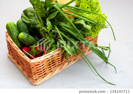Lollo Bionda Lettuce. Delivery of products. A set of greens for salad. Chives, lettuce, cucumbers, radishes, spinach, arugula. Isolated on a white background with place for text. Lollo Bionda Lettuce. Delivery of products. A set of greens for salad. Chives, lettuce, cucumbers, radishes, spinach, arugula. Isolated on a white background with place for text. 139145711