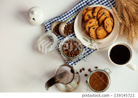 Breakfast top view. Coffee grains poured from a can on kitchen table. Coffee cup mood. Coffee bean, Food background. Still life with copy spase. Breakfast top view. Coffee grains poured from a can on kitchen table. Coffee cup mood. Coffee bean, Food background. Still life with copy spase. 139145721