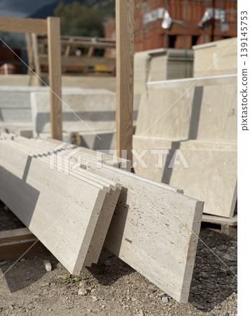 Stone slabs stacked at construction site with blurred background, highlighting industrial materials Stone slabs stacked at construction site with blurred background, highlighting industrial materials 139145753