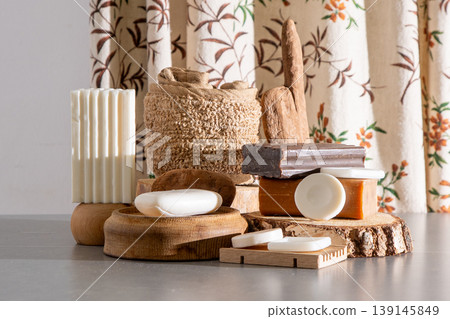Natural Handmade Soap Bars Collection on Wooden Podiums with Rustic Bath Accessories and Eco Decor. Assortment of Soaps and Loofah Natural Handmade Soap Bars Collection on Wooden Podiums with Rustic Bath Accessories and Eco Decor. Assortment of Soaps and Loofah 139145849