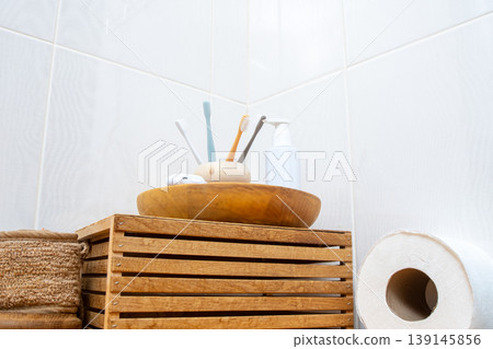 Bathroom Essentials on Wooden Tray. Dental Care and Hygiene Set with Toothbrushes Floss and Soap on Eco Friendly background Bathroom Essentials on Wooden Tray. Dental Care and Hygiene Set with Toothbrushes Floss and Soap on Eco Friendly background 139145856