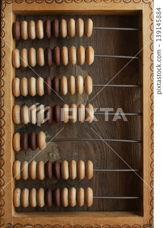 Old arithmetic abacus on the desk top view background with copy space. 139145884