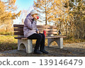 old age, retirement and people concept - close up of happy senior woman at autumn park drinking takeaway coffee 139146479