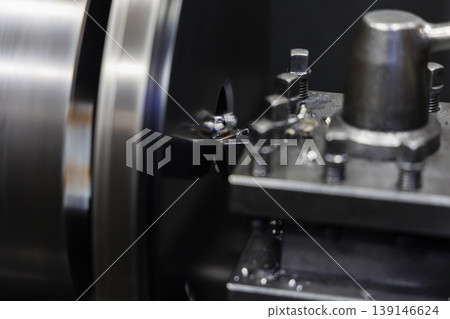 Precision metalworking scene using an NC lathe. Cutting technology in a manufacturing plant. Commercial use. Advertising material. Image. Precision metalworking scene using an NC lathe. Cutting technology in a manufacturing plant. Commercial use. Advertising material. Image. 139146624