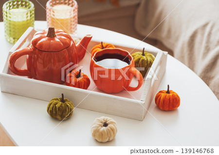 Autumnal living room decor with pumpkins, tea set and cake. Autumnal living room decor with pumpkins, tea set and cake. 139146768
