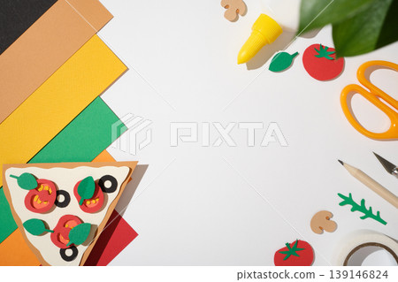 Top view of DIY craft project pizza on white background with scissors, pencil, and paper sheets. Copyspace Top view of DIY craft project pizza on white background with scissors, pencil, and paper sheets. Copyspace 139146824