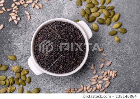 Black sesame seeds in a bowl, an ingredient for oil and healthy eating. Black sesame Black sesame seeds in a bowl, an ingredient for oil and healthy eating. Black sesame 139146864