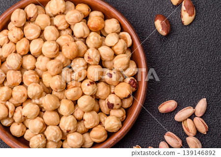 Whole peeled hazelnuts, roasted or raw, as an ingredient for healthy food. Hazelnuts as a background Whole peeled hazelnuts, roasted or raw, as an ingredient for healthy food. Hazelnuts as a background 139146892