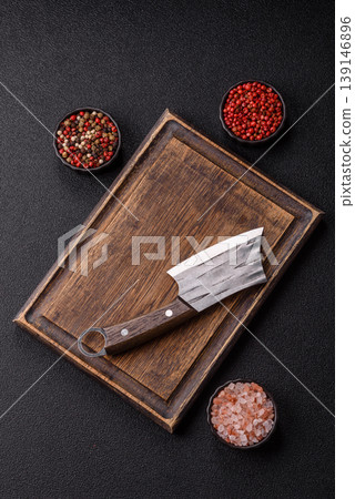 An empty wooden cutting board with cutlery on a kitchen counter. A wooden cutting board 139146896