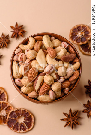 A mix of cashews, pistachios, almonds, brazil nuts and hazelnuts. Nuts as a food background A mix of cashews, pistachios, almonds, brazil nuts and hazelnuts. Nuts as a food background 139146942