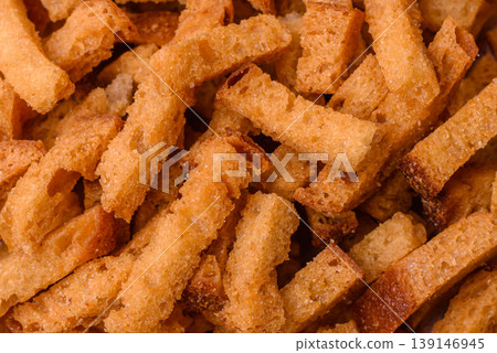 Croutons or crackers made from rye bread with garlic, salt, and spices. Croutons with salt Croutons or crackers made from rye bread with garlic, salt, and spices. Croutons with salt 139146945